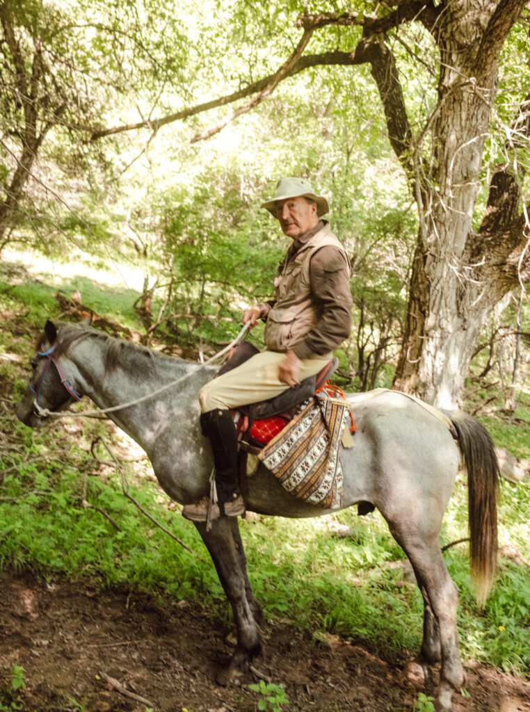 Charles Moore, writer for "the Spectator", on horseback in Kyrgyzstan being part of Alexandra Tolstoy Travel